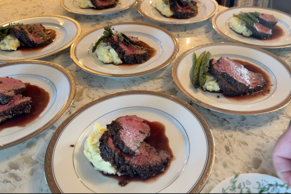 Plated beef tenderloin courses on fine china for a Culinary & Cork private dinner