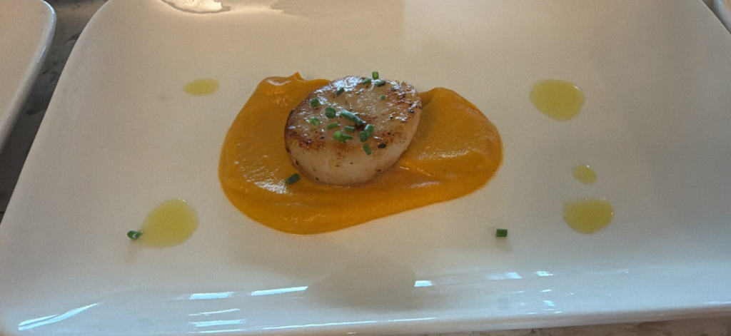 Seared scallop on butternut squash purée with chives, plated by Culinary & Cork