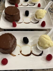 Chocolate torte with vanilla ice cream and fresh berries, plated dessert course by a private chef in Barrie