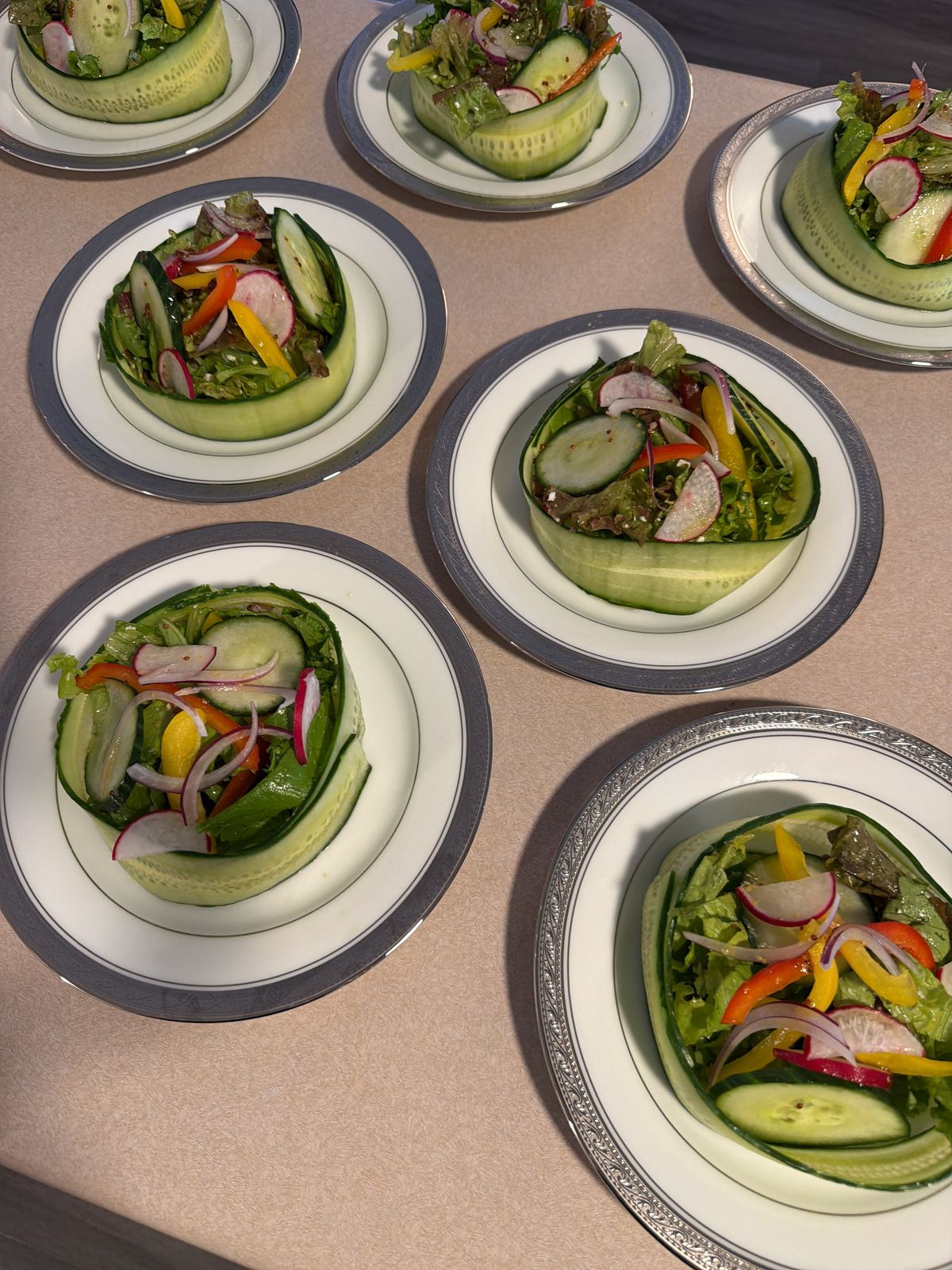 Cucumber-wrapped garden salad plated on fine china by a private chef in Barrie, Ontario