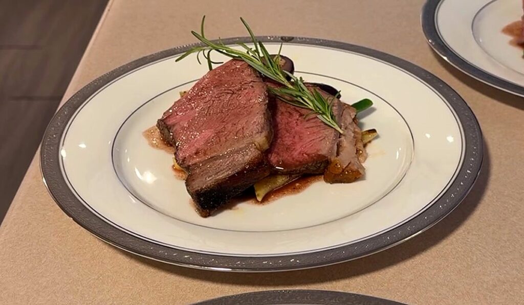 Plated prime rib with rosemary and jus on fine china, private chef dinner in Barrie, Ontario
